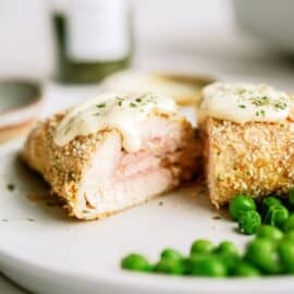 easy chicken cordon blue slice on a plate with peas