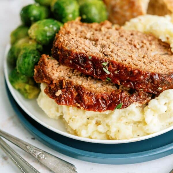 meatloaf slices with brussel sprouts on mashed potatoes