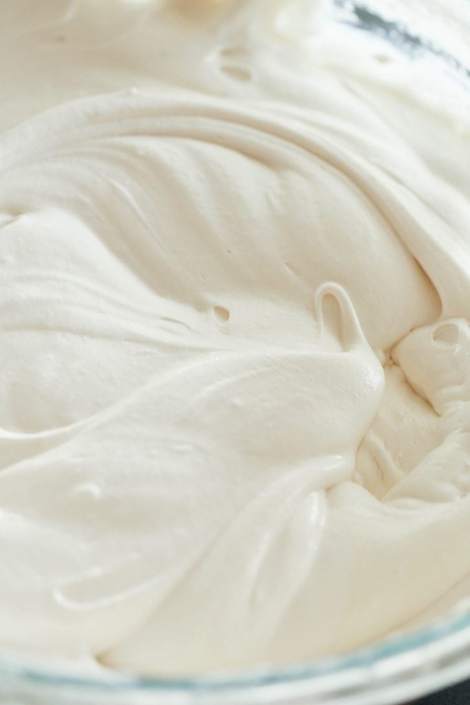 Cream Cheese frosting mixed together in a glass mixing bowl.