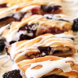 blackberry danish with icing on a baking tray