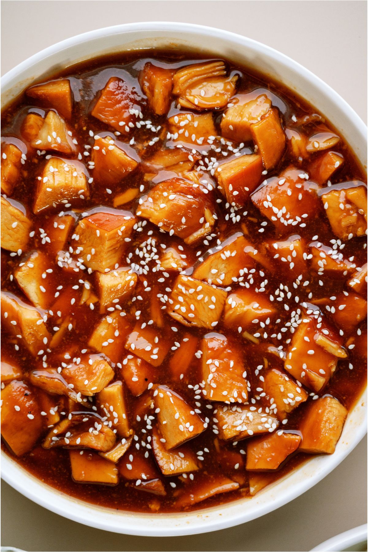 Close up of Slow Cooker Honey Sesame Chicken in a serving bowl.