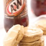 Frosted cookies next to a bottle of A&W Root Beer.