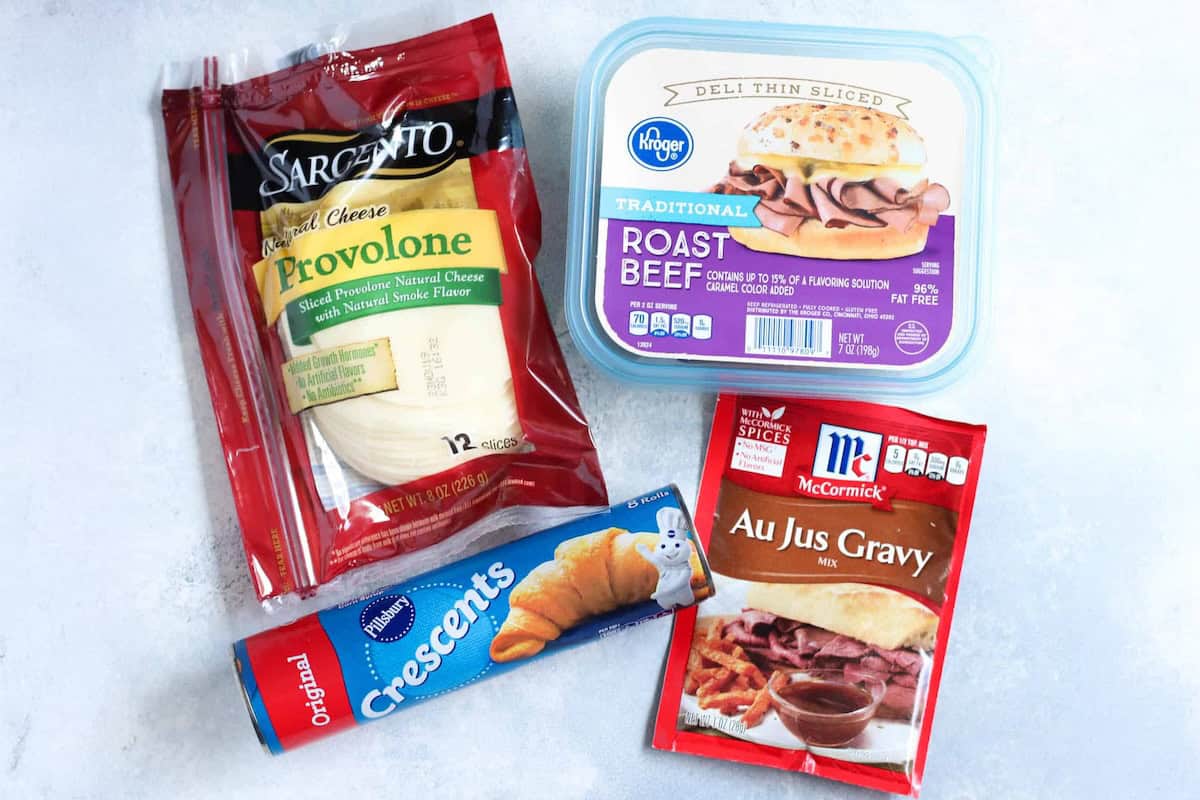 Ingredients needed for French Dip Crescents. Deli Roast Beef, Sliced Cheese, Crescent Roll Dough and Au Jus Sauce Packet.