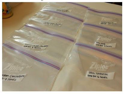 8 ziplock bags on a counter with individual meal recipes written on the bags
