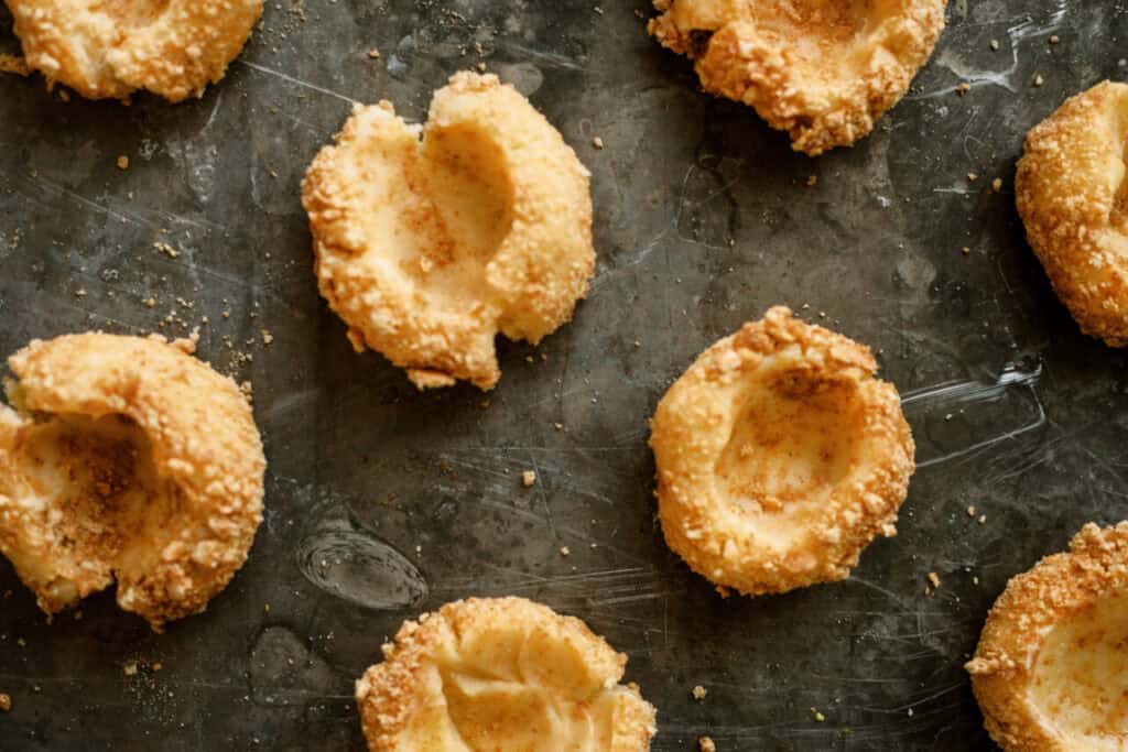 Baked Cherry Cheesecake Cookie bases with a thumb imprint in each coolie for the cherry filling.