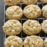 White Chocolate Chip Oatmeal Cookies line up on a cooling rack.