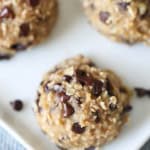 Top view of 3 Skinny Banana Cookies on a plate with mini chocolate chips around them.