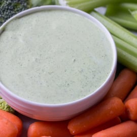 Easy Spinach Dip in a bowl surrounded by vegetables