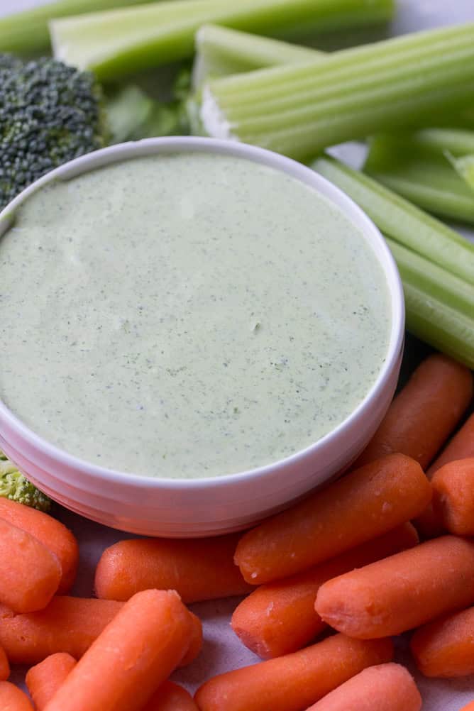 Easy Spinach Dip in a bowl surrounded by vegetables