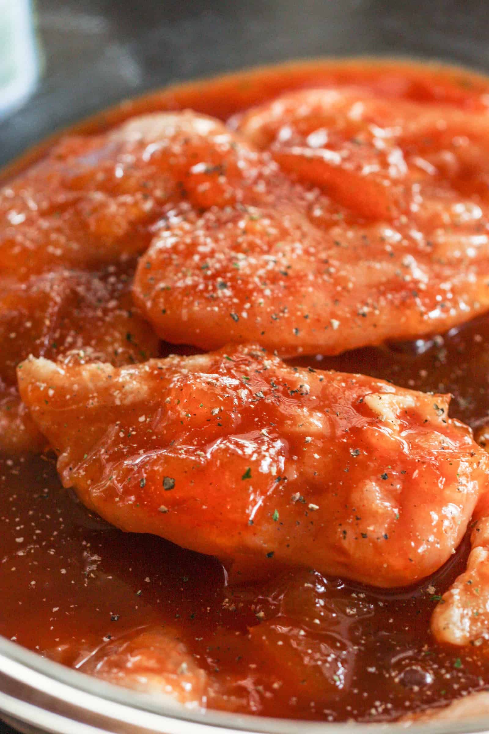 Raw chicken covered with Barbecue Peach Chicken marinade
