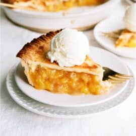 A slice of Fresh Peach Pie on a plate