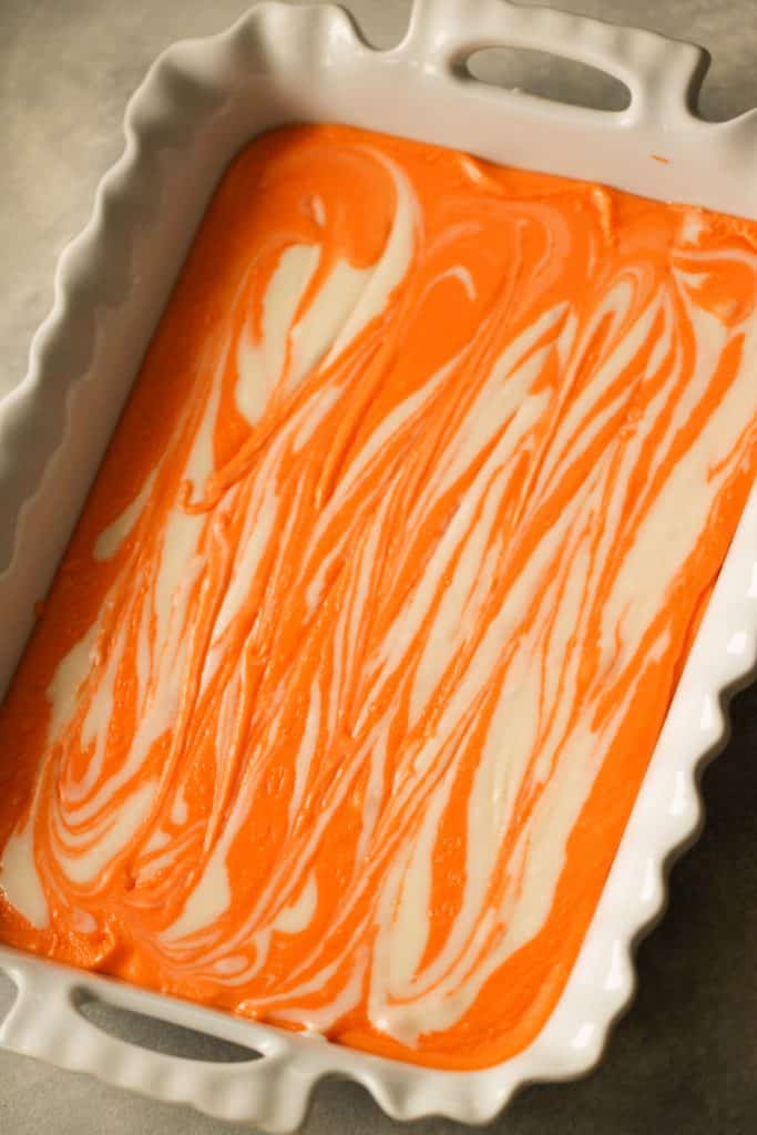 Orange Creamsicle Fudge with white swirls in a 9x13 dish.