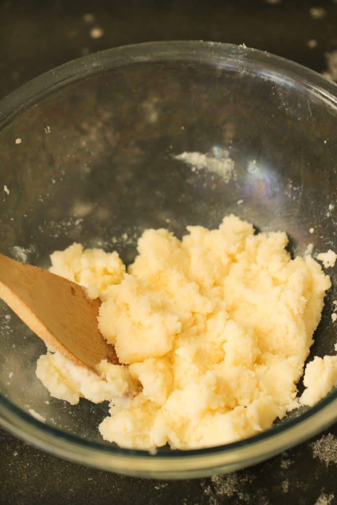 Wet Ingredients mixed together in a glass bowl with a wooden spoon.