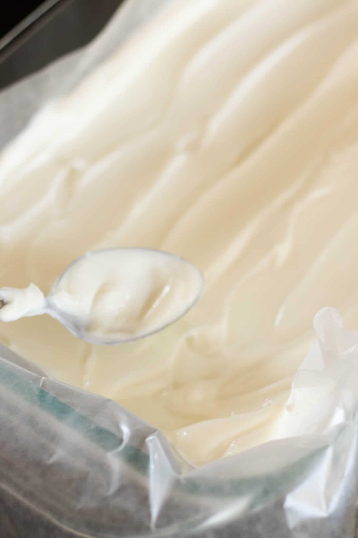 Yogurt Honey Mixture spread evenly on a parchment lined sheet pan.