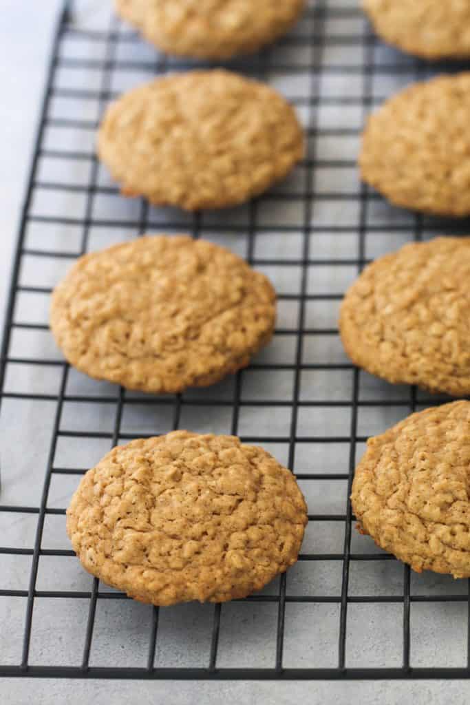 Oatmeal cookies on a cooling rack.