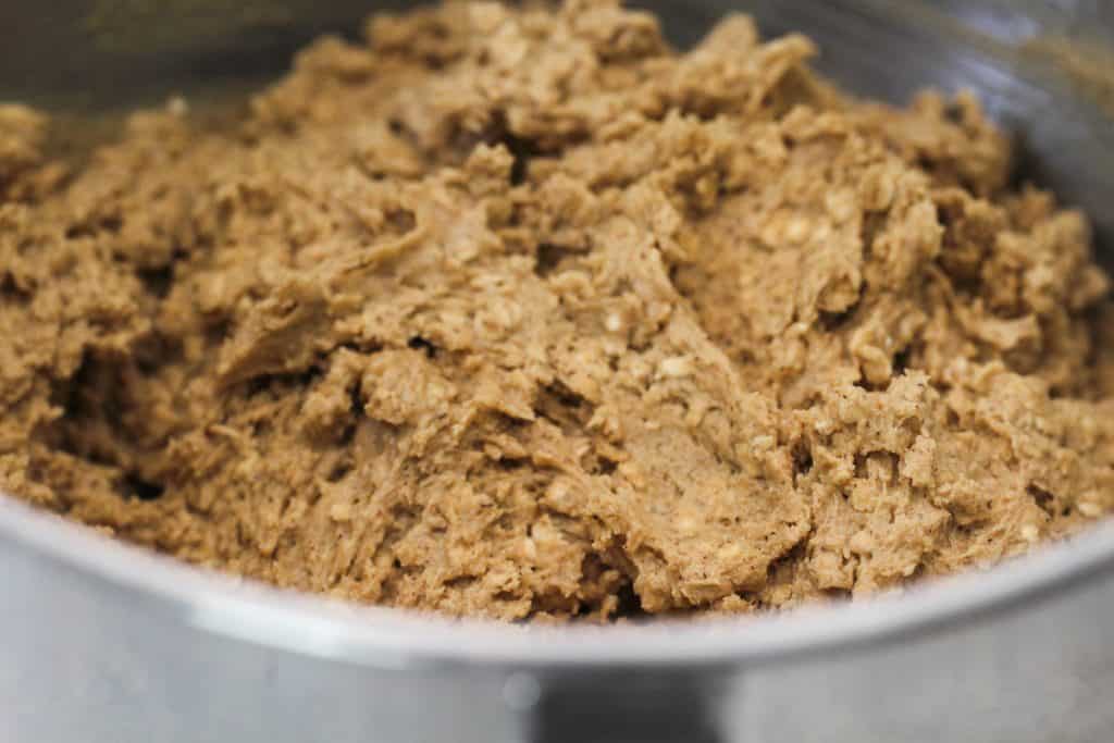 Large mixing bowl full of oatmeal cookie dough.