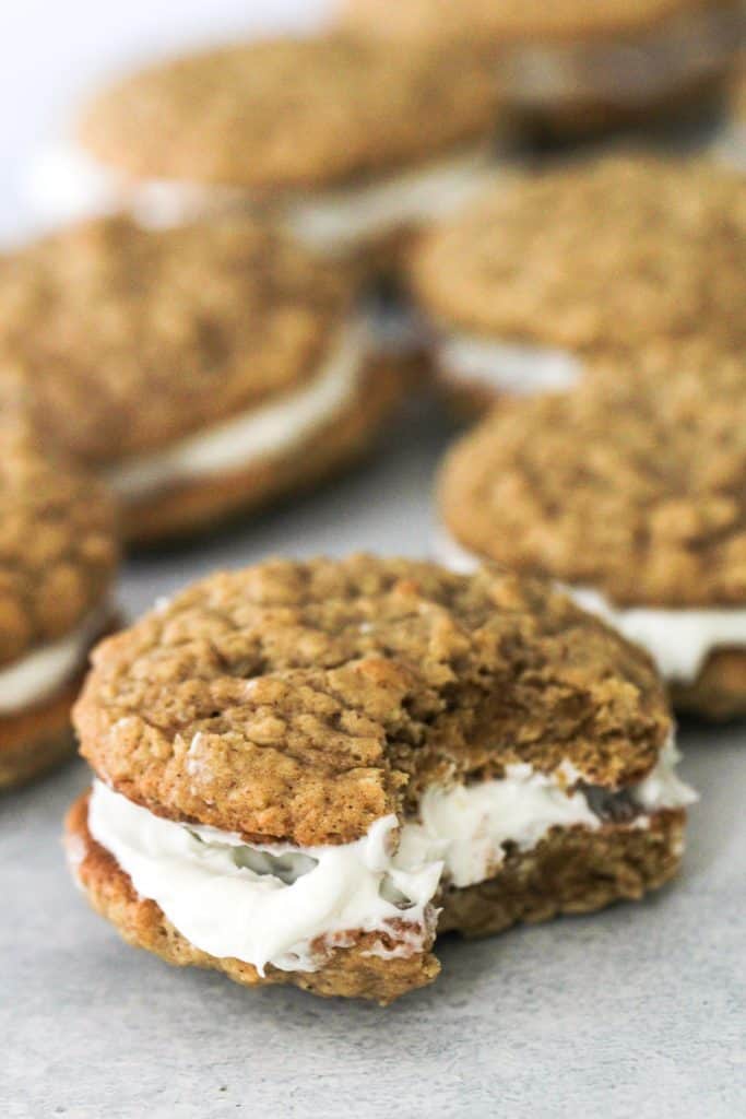 Oatmeal Creme Pies with the front cookie missing a bite.