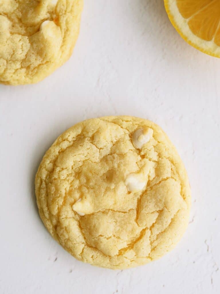 Top view of 3 Lemon Cheesecake Pudding Cookies on a white background.