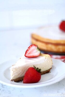 Lion House copycat cheesecake on a plate with a strawberry slice on top