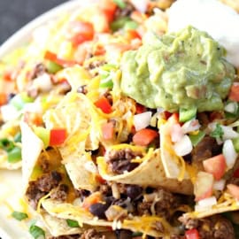 rainforest cafe loaded nachos on a plate with avocado