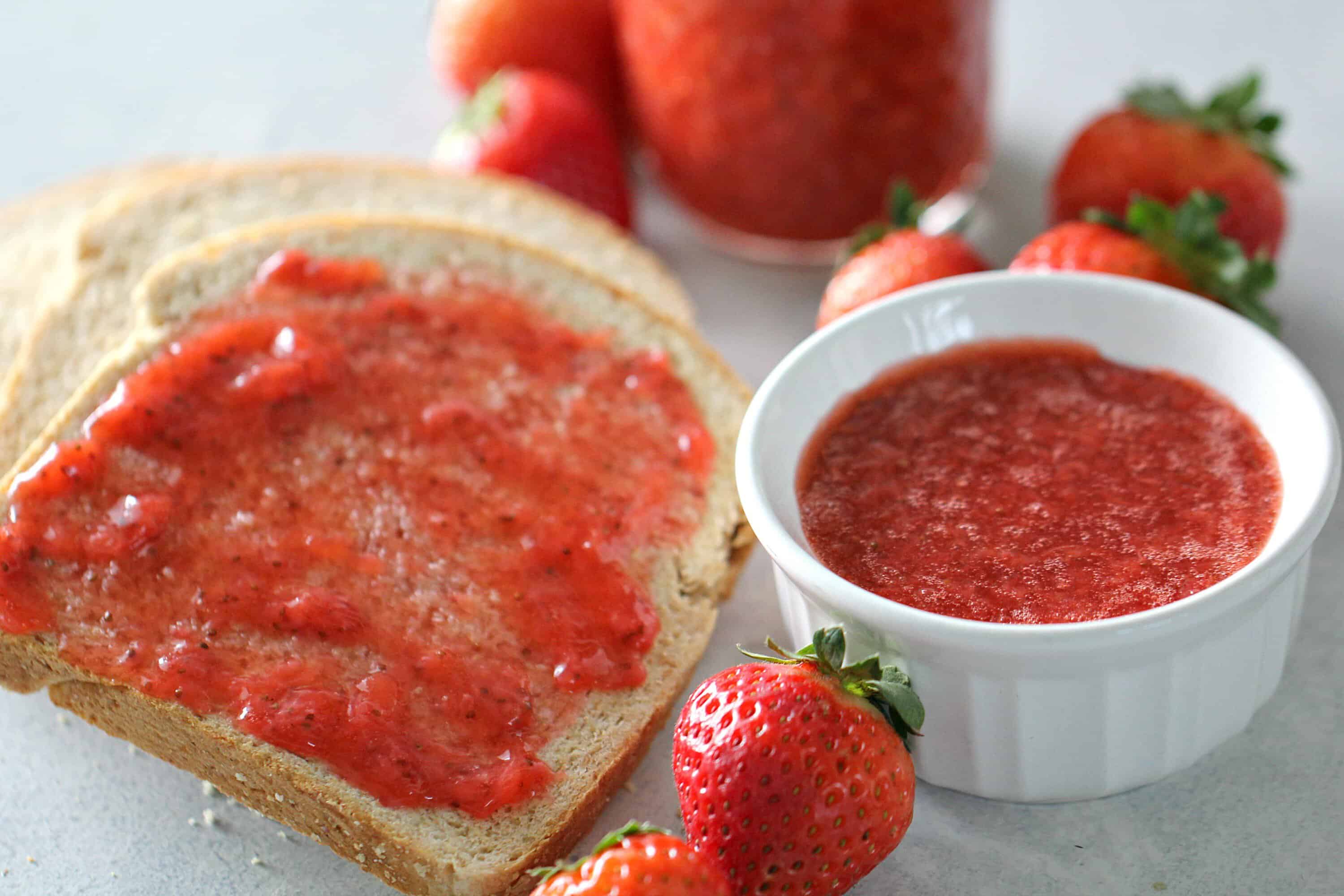 A slice of bread with Instant Pot Strawberry Jam spread on top