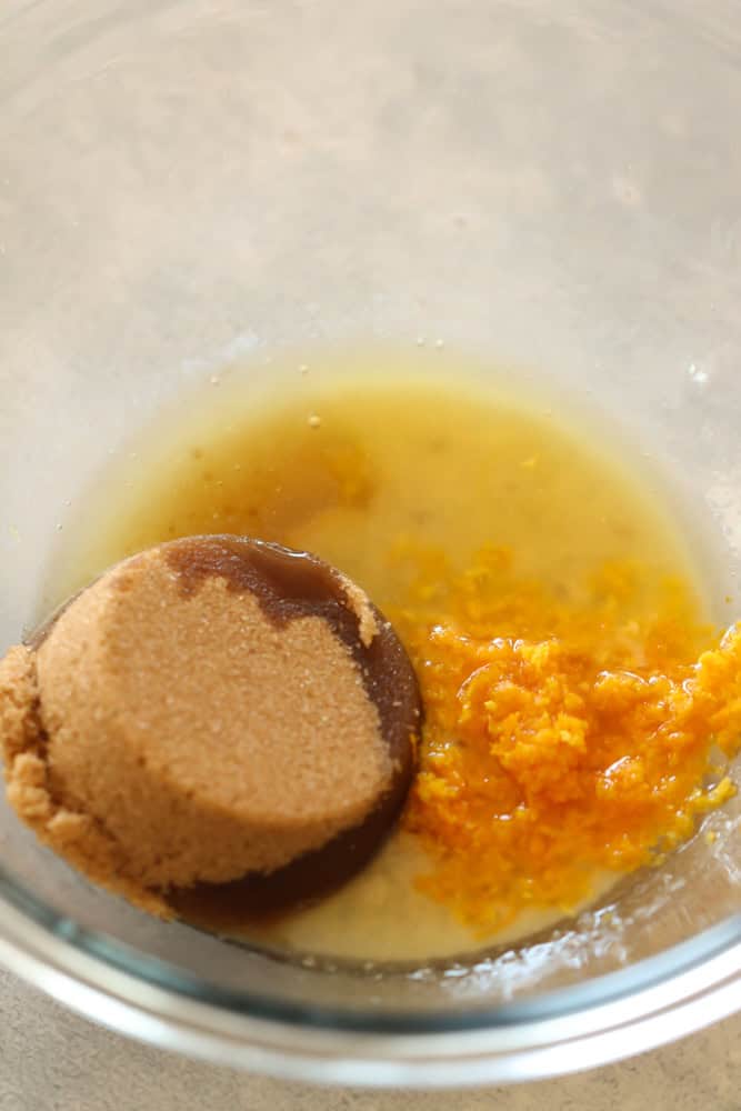 brown sugar, melted butter, maple syrup, and orange zest combined in a mixing bowl