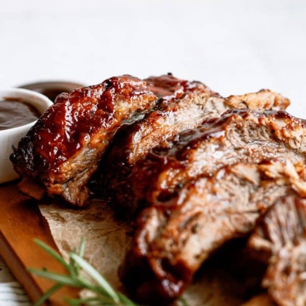 Sliced Instant Pot Fall Off the Bone BBQ Ribs on a cutting board with sauce