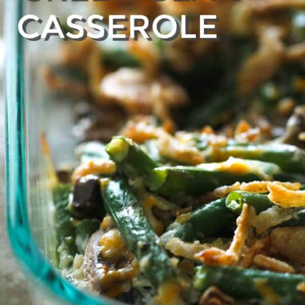 Close-up of a homemade green bean casserole in a glass dish, topped with crispy onions.