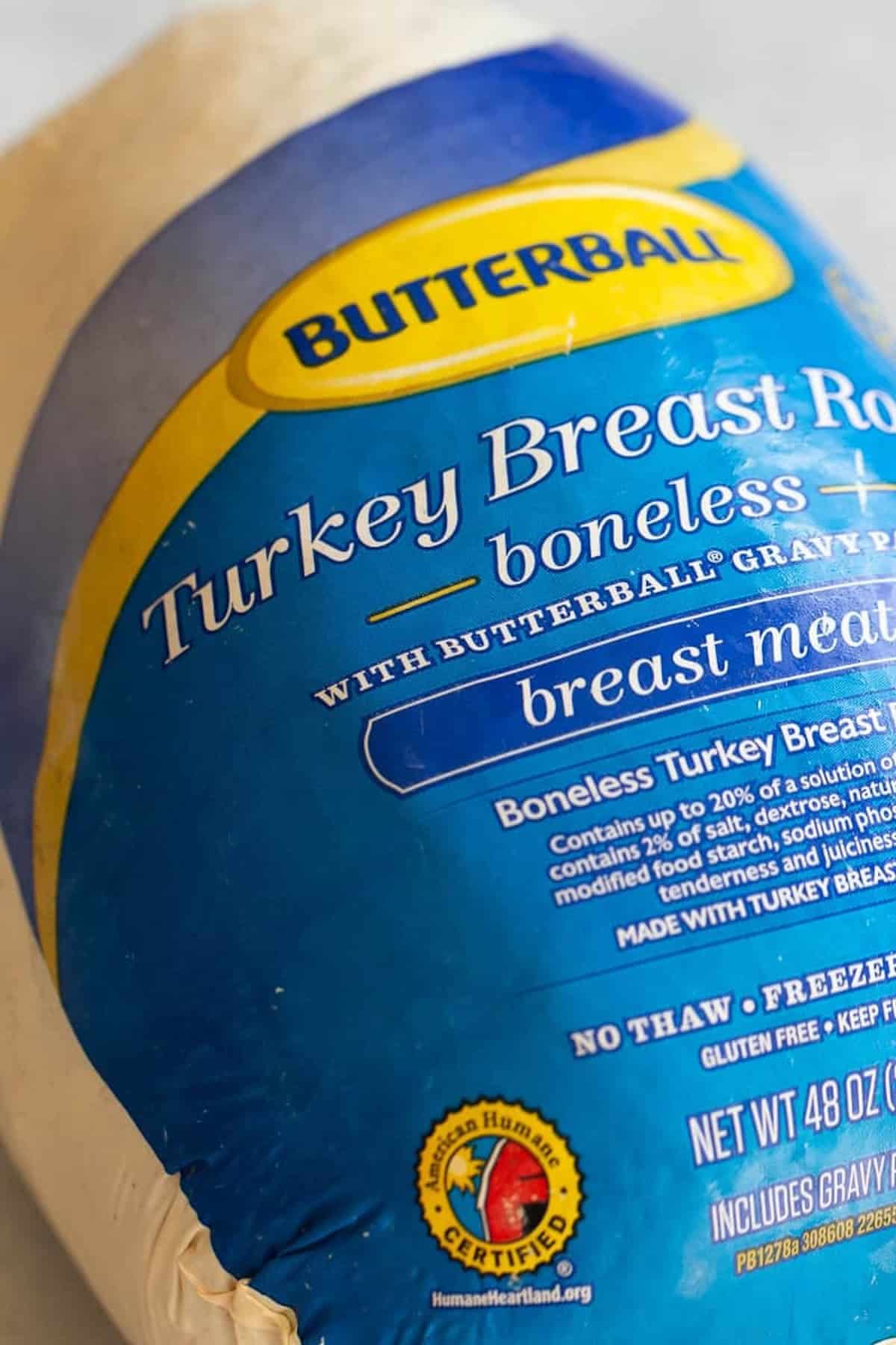 Close-up of a Butterball boneless turkey breast roast package. The label indicates it includes gravy packets and is certified by the American Humane Association.