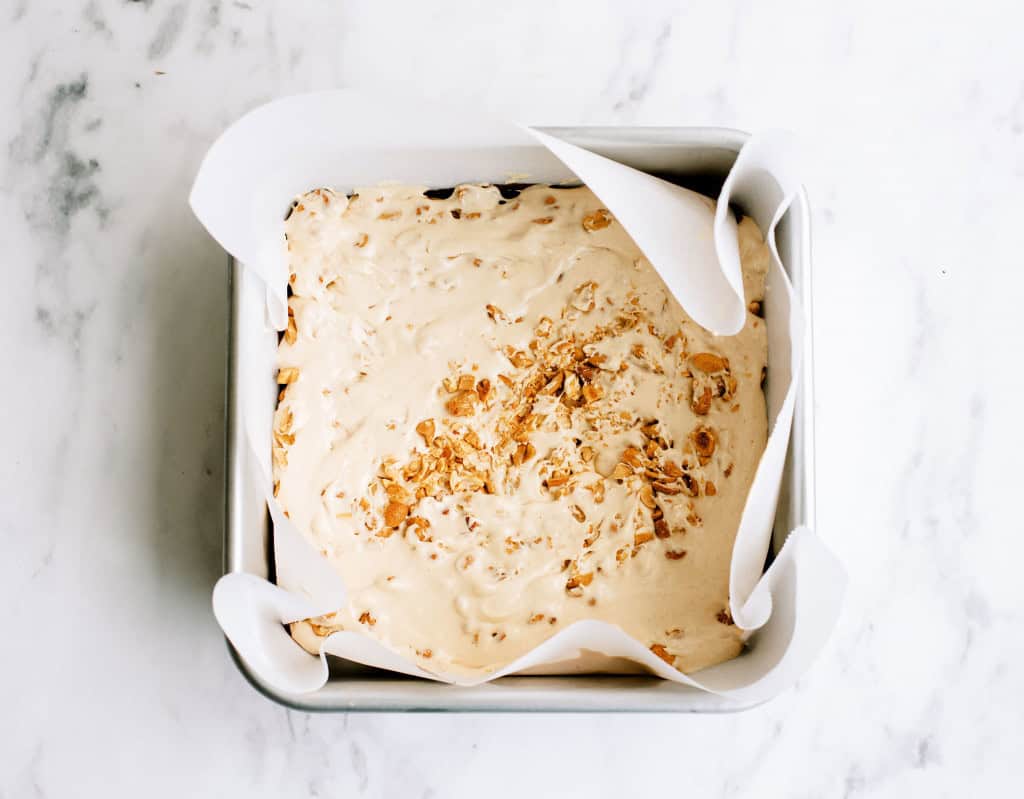 Marshmallow and Peanut layer on top of chocolate layer in a square pan.