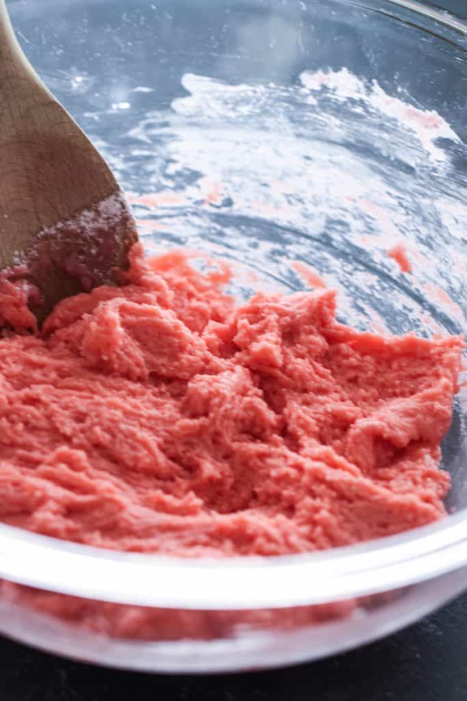 Strawberry cookie dough in a glass mixing bowl.