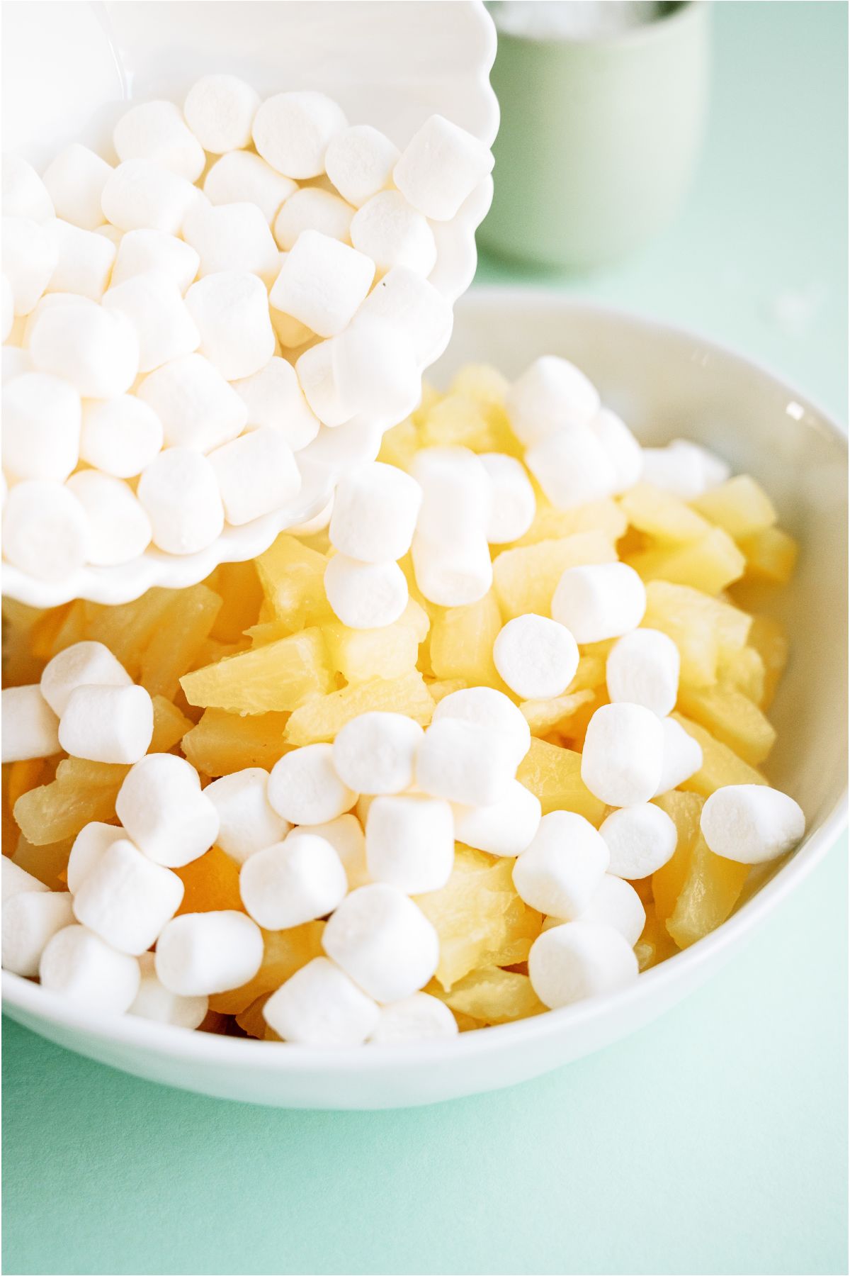 Fruit and Marshmallows added to a large mixing bowl.