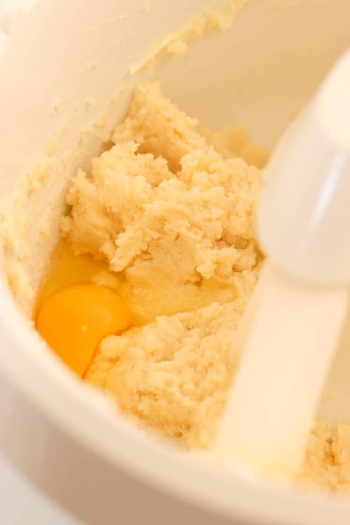 Stand mixer mixing together dough for sugar cookies.