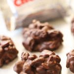 Copycat Chunky Bar Clusters on parchment paper with a Chunky Bar candy wrapped in the background.