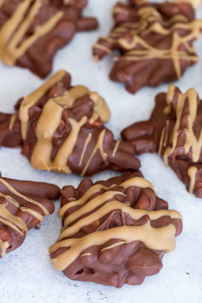 Chubby Hubby clusters with peanut butter drizzle on top of wax paper.