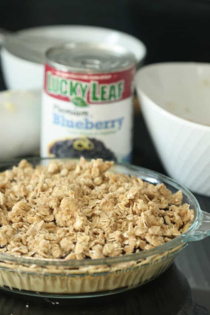 Blueberry Crumble Pie with a can of blueberry pie filling in the background. 