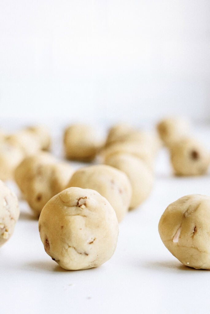 Small balls of cookie dough lined in rows.