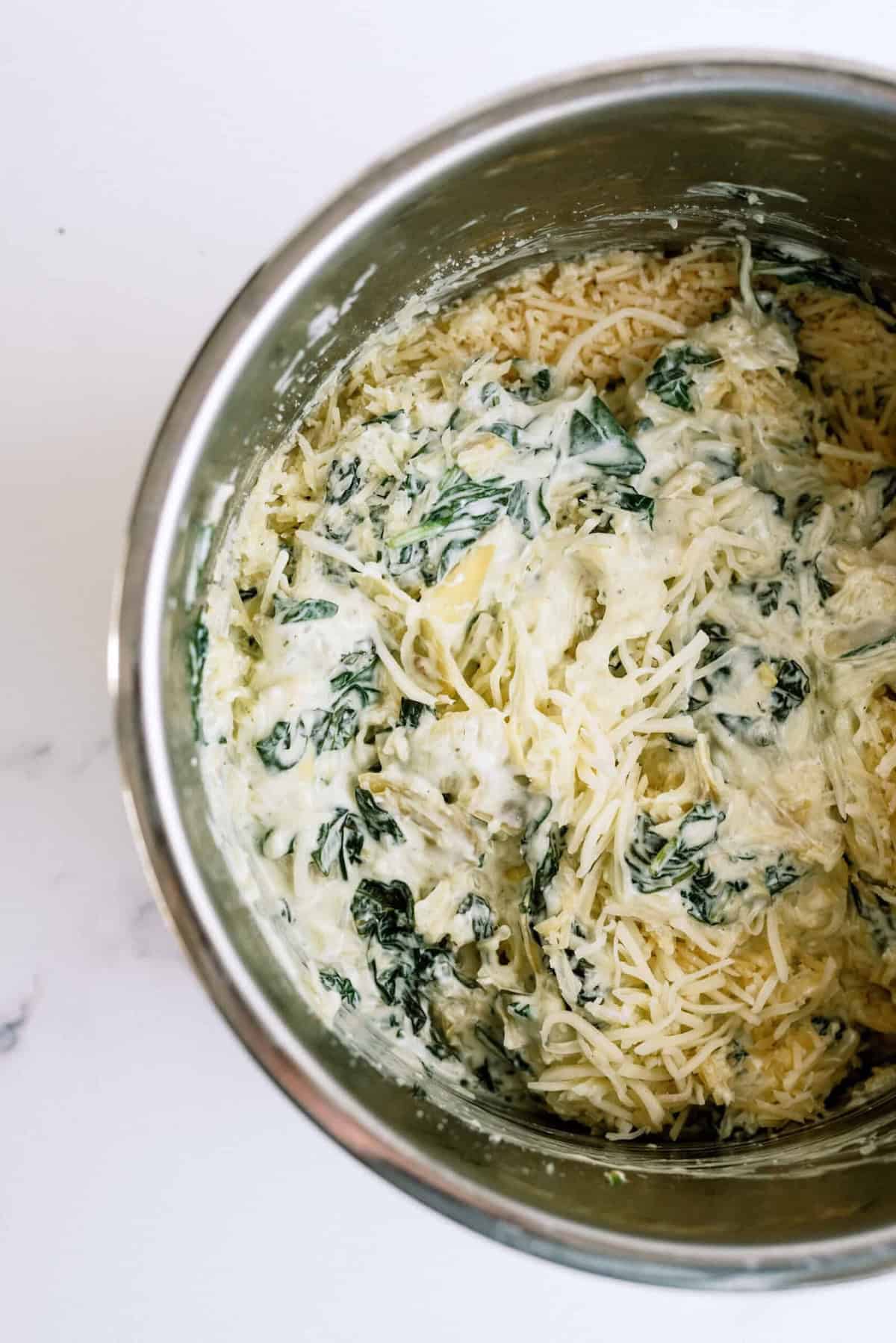 Instant Pot Spinach Artichoke Dip with cheese to mix in on top