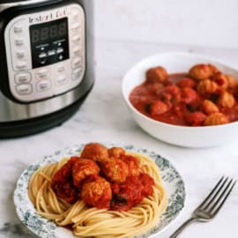 Instant Pot Italian Meatballs plated with spaghetti noodles