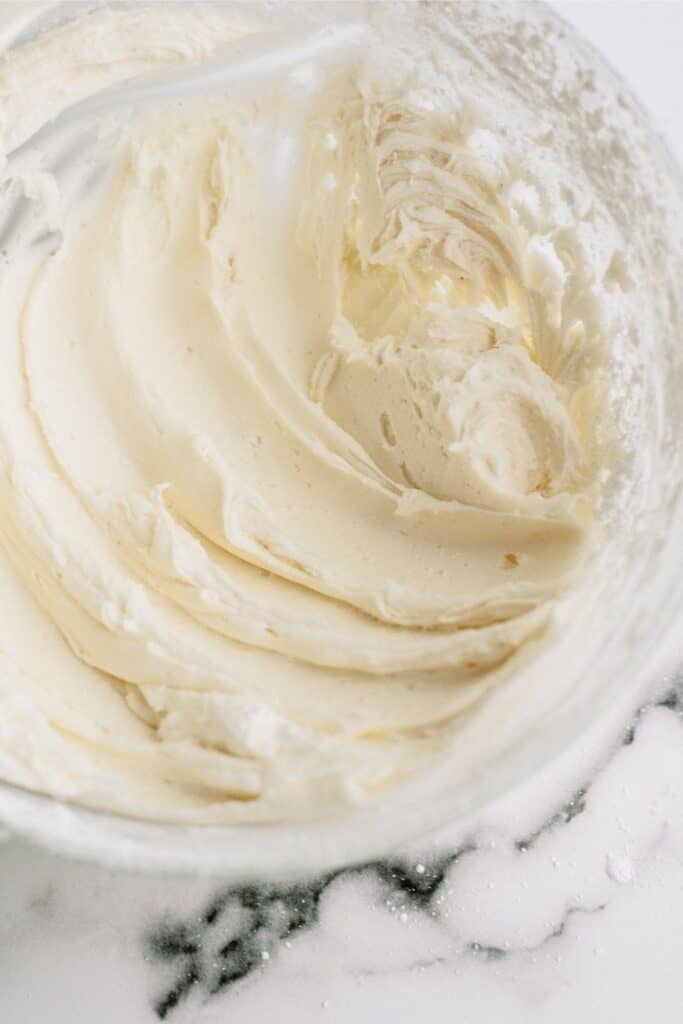 Frosting mixed together in glass mixing bowl.