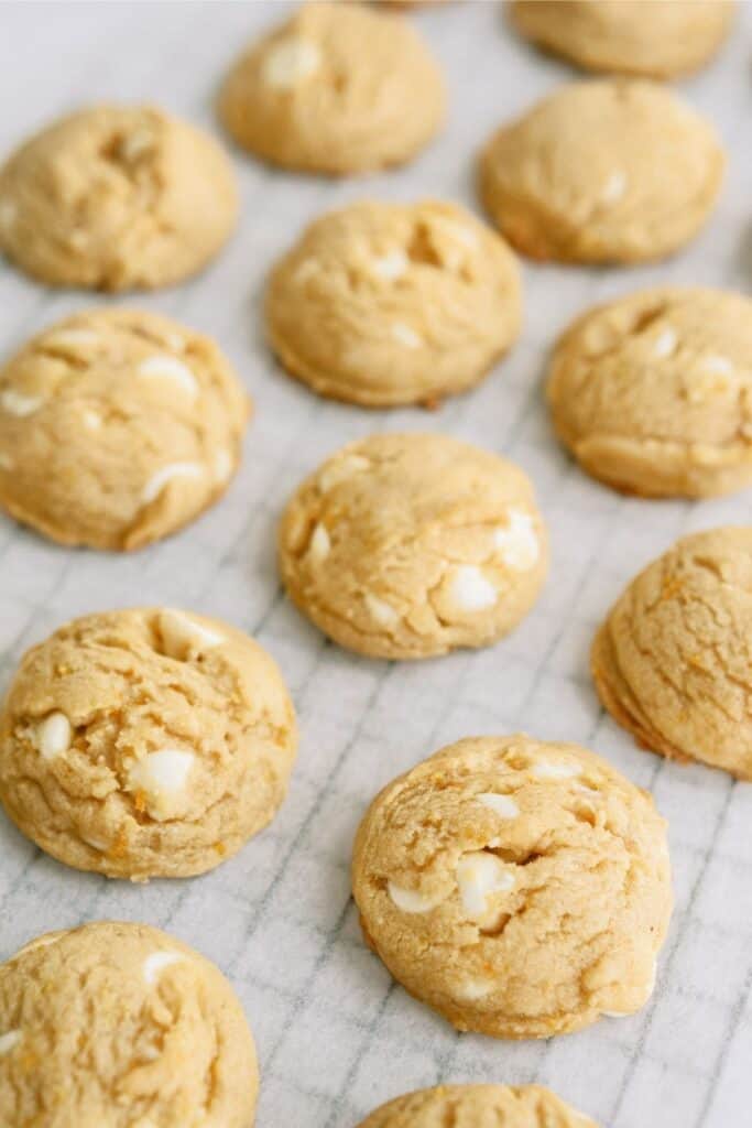 Orange Creamsicle Cookies on a cooling rack lined with parchment paper.