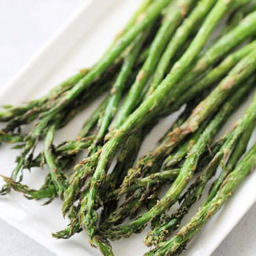 Air Fryer Asparagus on a white serving platter.