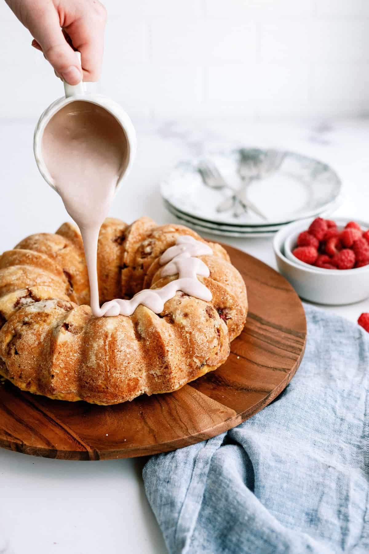 Raspberry Frosting poured on Fresh Raspberry Yogurt Bundt Cake