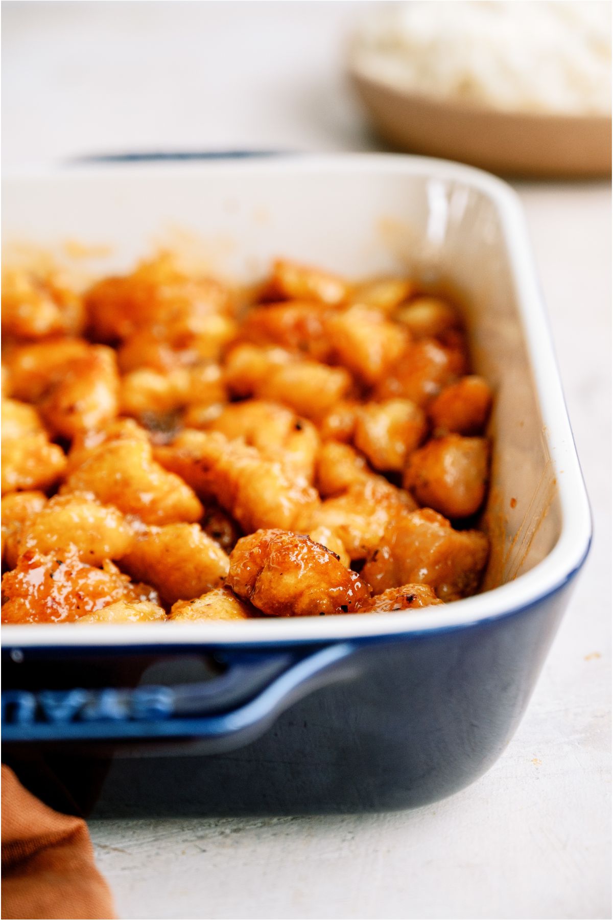 A baking dish filled with Baked Sweet and Sour Chicken.