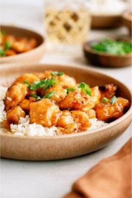 A plate of Baked Sweet and Sour Chicken served over white rice.