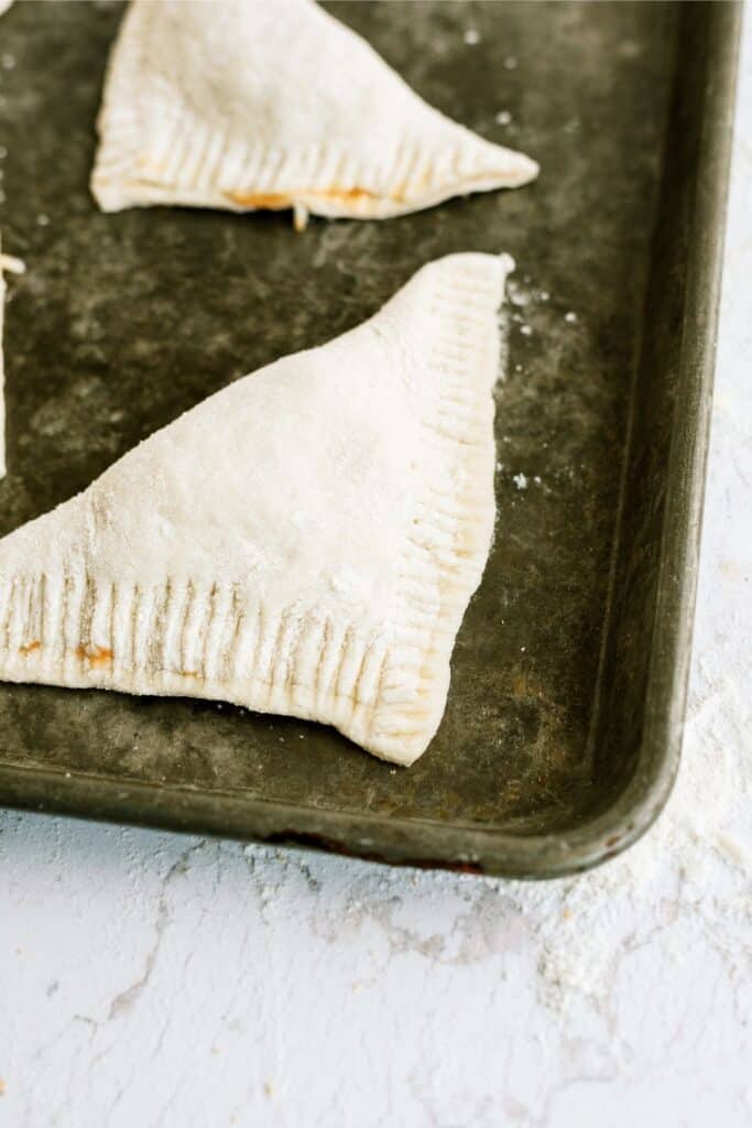 Unbaked Quick and Easy Calzones on a baking sheet.