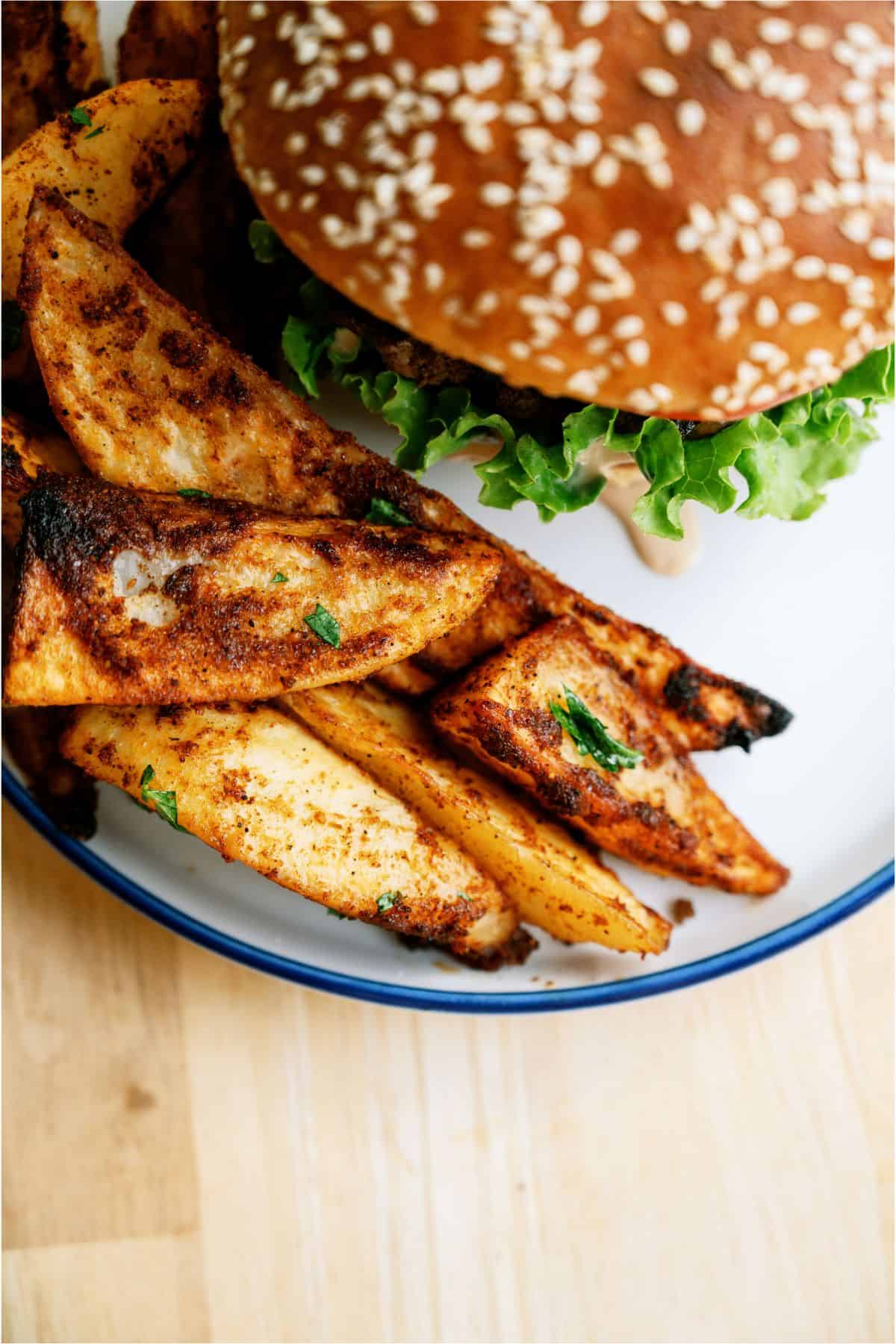 Top view of a plate with a burger and Oven Baked Seasoned Steak Fries