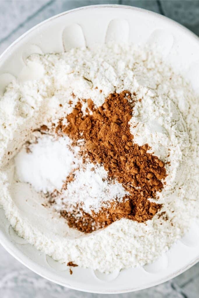 Dry ingredients for Chocolate Zucchini Sheet Cake in a mixing bowl.