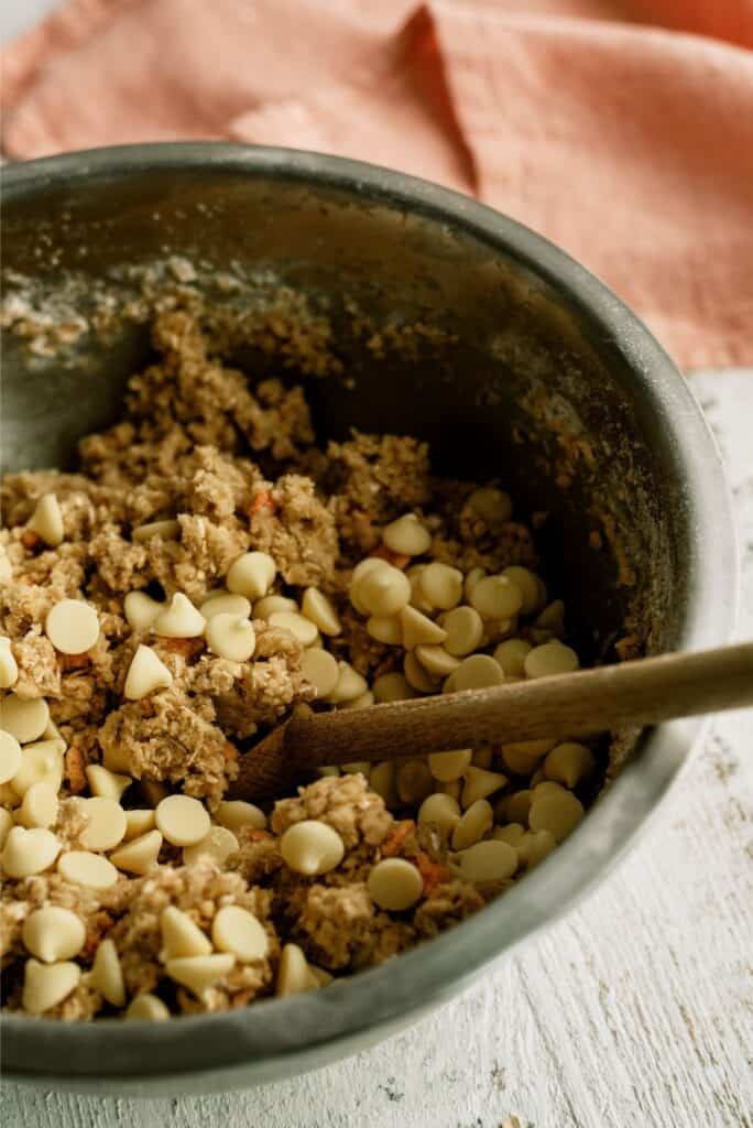 Folding white chocolate chips into Peaches and Cream Oatmeal Cooke dough.