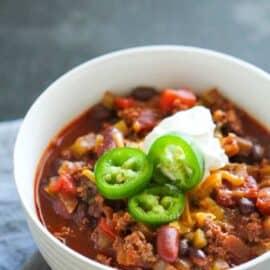 A bowl of The Best Homemade Chili Recipe with sour cream and jalapenos